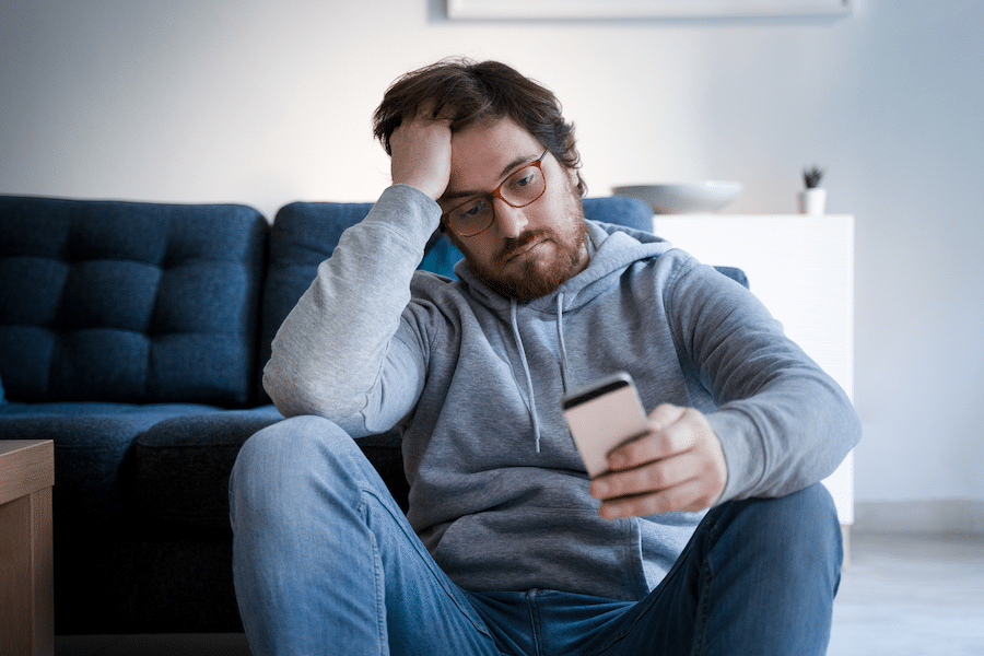 man checking social media after breakup