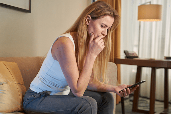woman checking social media after breakup